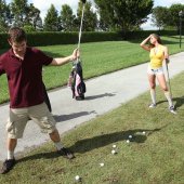 Rachel Roxxx watches as Shane Dizzle tries to play golf